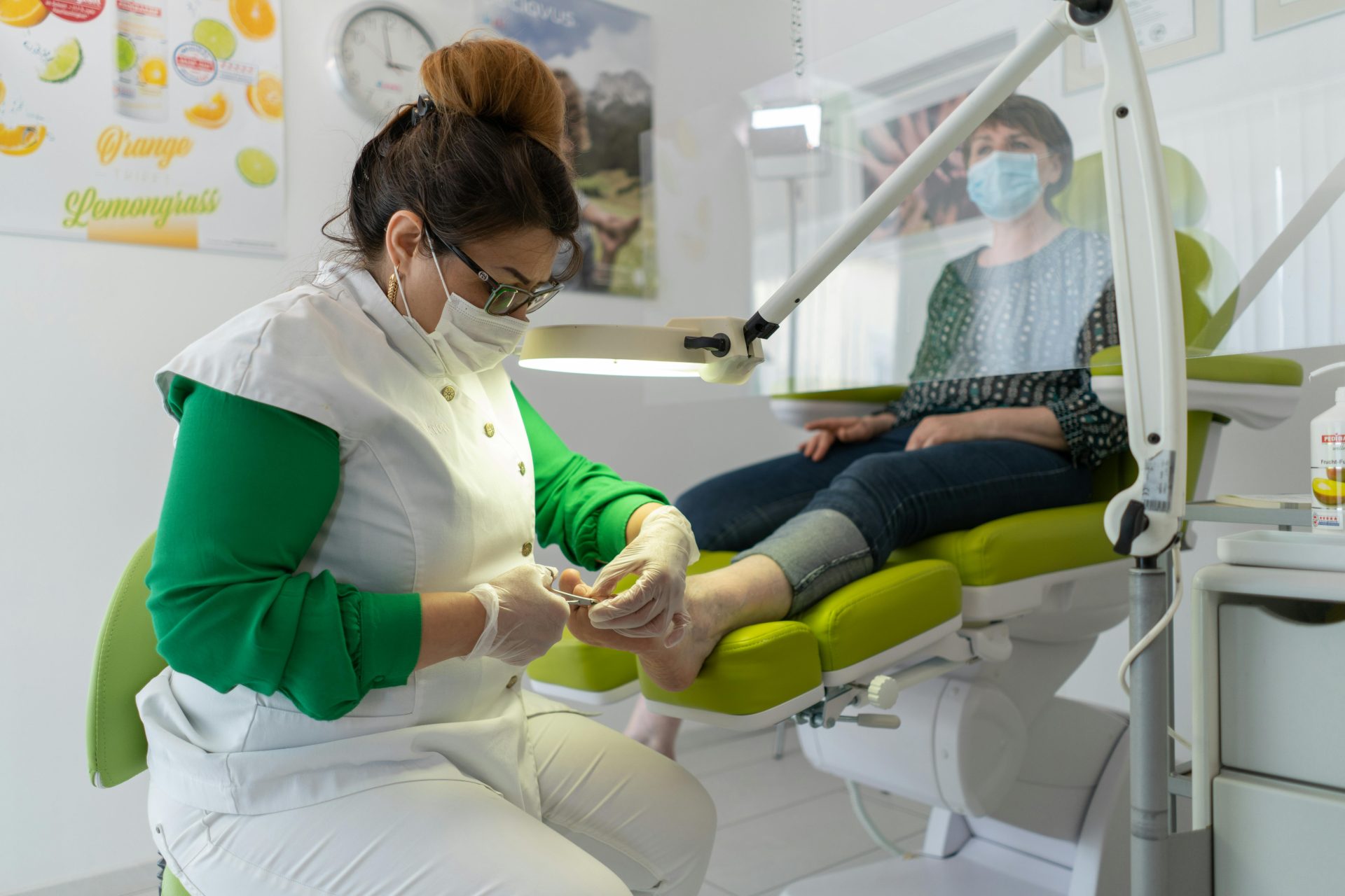 A beautician provides a pedicure in a modern spa setting, focusing on foot care and relaxation.